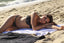 Woman lying on a towel at the beach